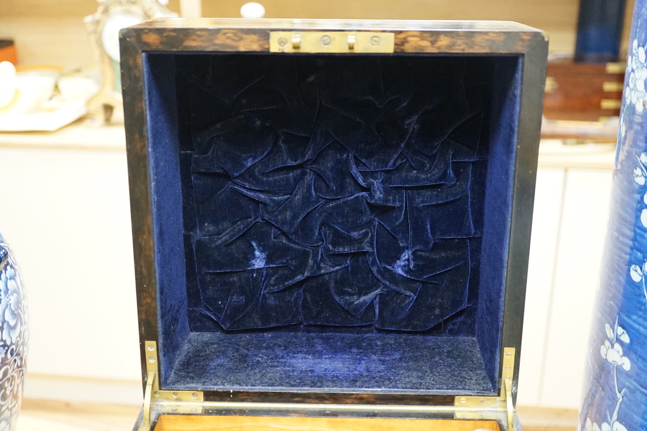 A Victorian coromandel four bottle decanter box with Bramah lock, three silver ‘hunting’ spirit labels and another enamelled, height of box 30cm